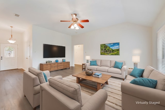 living room featuring a wealth of natural light, vaulted ceiling, light hardwood / wood-style floors, and ceiling fan