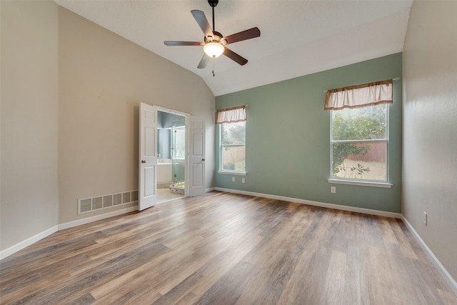 spare room featuring lofted ceiling, hardwood / wood-style flooring, and ceiling fan