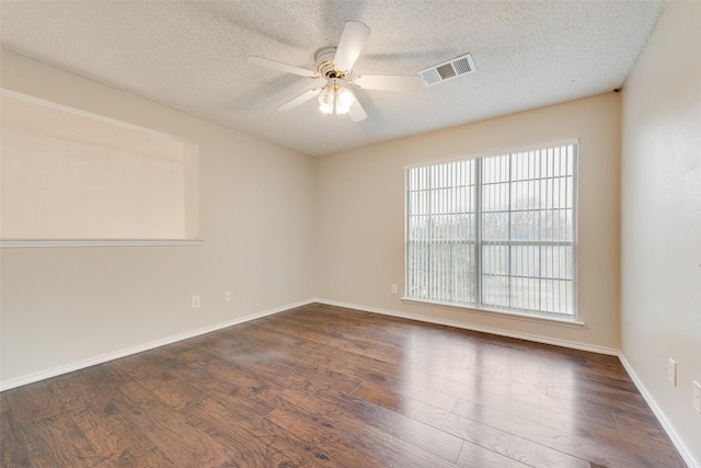 unfurnished room featuring ceiling fan, dark hardwood / wood-style floors, and a textured ceiling