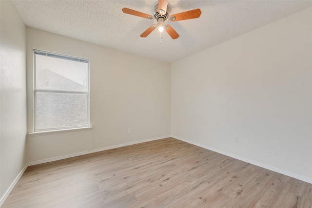 spare room featuring ceiling fan, light hardwood / wood-style floors, and a textured ceiling