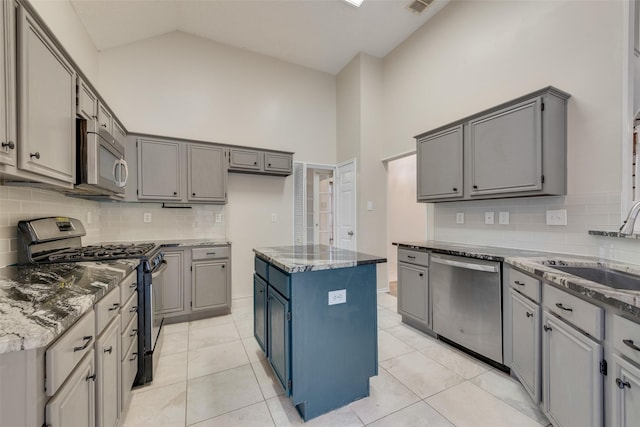 kitchen featuring gray cabinetry, a center island, and appliances with stainless steel finishes