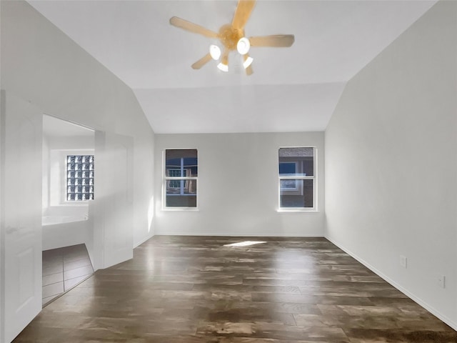 empty room featuring dark wood-type flooring, ceiling fan, and vaulted ceiling