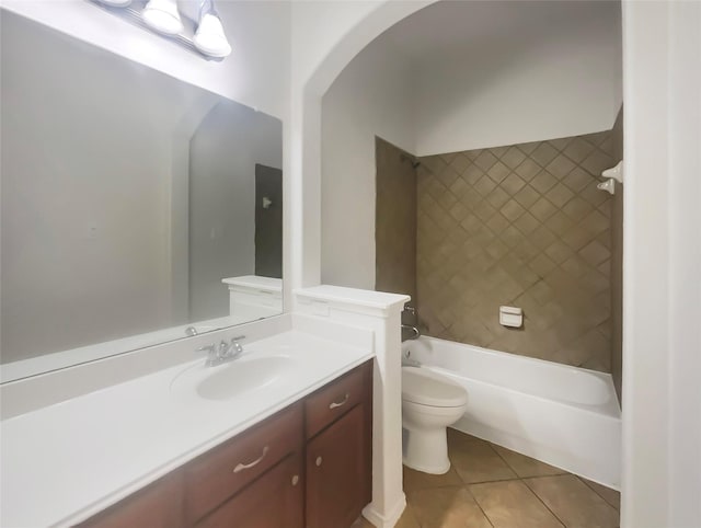 full bathroom featuring tiled shower / bath combo, vanity, tile patterned floors, and toilet