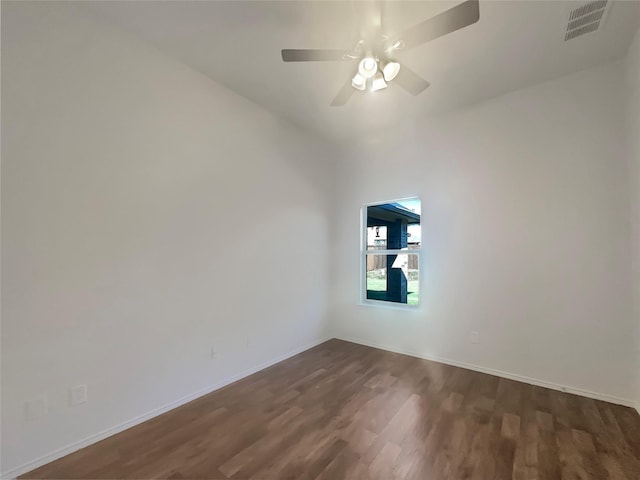 spare room featuring dark wood-type flooring and ceiling fan