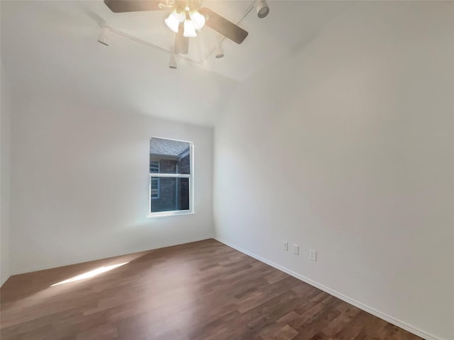 unfurnished room with dark wood-type flooring, rail lighting, and ceiling fan