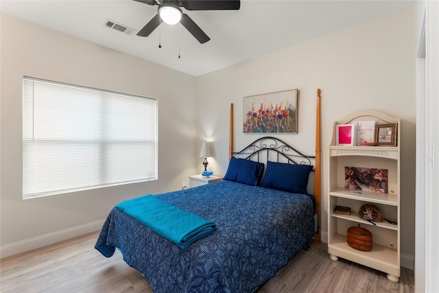 bedroom featuring hardwood / wood-style floors and ceiling fan