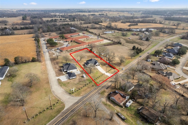 birds eye view of property with a rural view