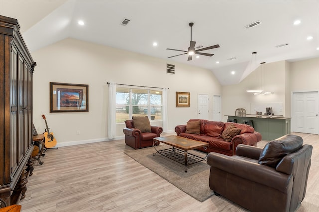 living room featuring high vaulted ceiling, light hardwood / wood-style floors, and ceiling fan