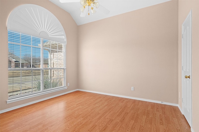 empty room featuring a ceiling fan, light wood-style flooring, and baseboards