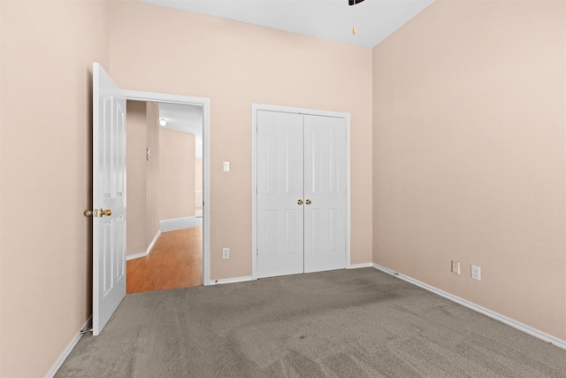 unfurnished bedroom featuring baseboards, a closet, and carpet flooring