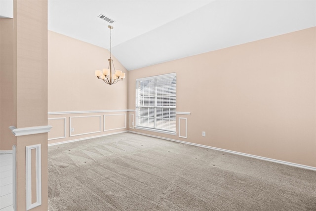 unfurnished room with a decorative wall, light colored carpet, visible vents, vaulted ceiling, and an inviting chandelier