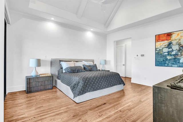 bedroom featuring lofted ceiling with beams and light wood-type flooring