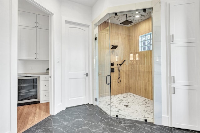 bathroom with an enclosed shower and beverage cooler