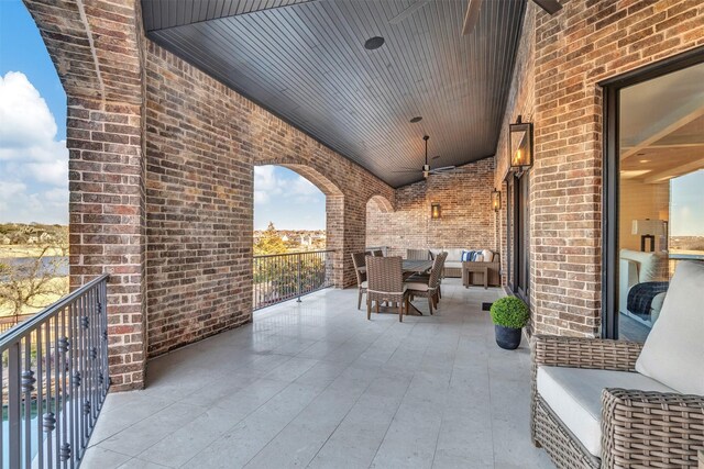 view of patio / terrace with a balcony and ceiling fan