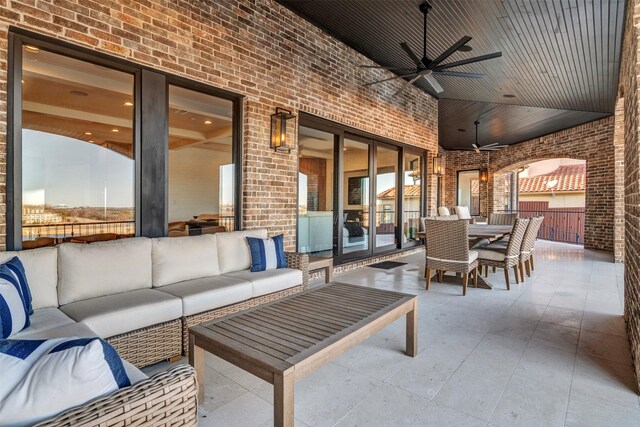 view of patio with an outdoor living space and ceiling fan