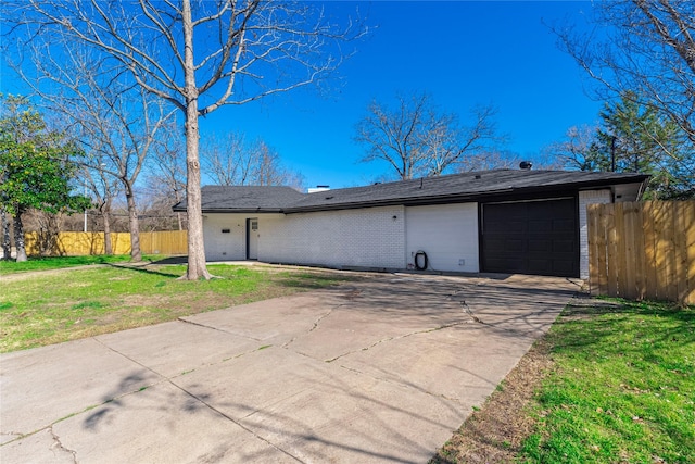 exterior space with a garage and a front lawn