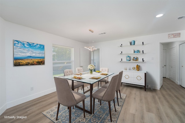 dining space with light hardwood / wood-style flooring