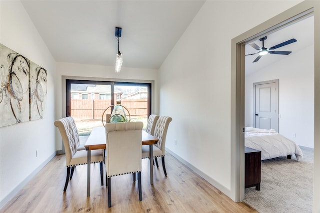 dining room featuring vaulted ceiling and light wood-type flooring