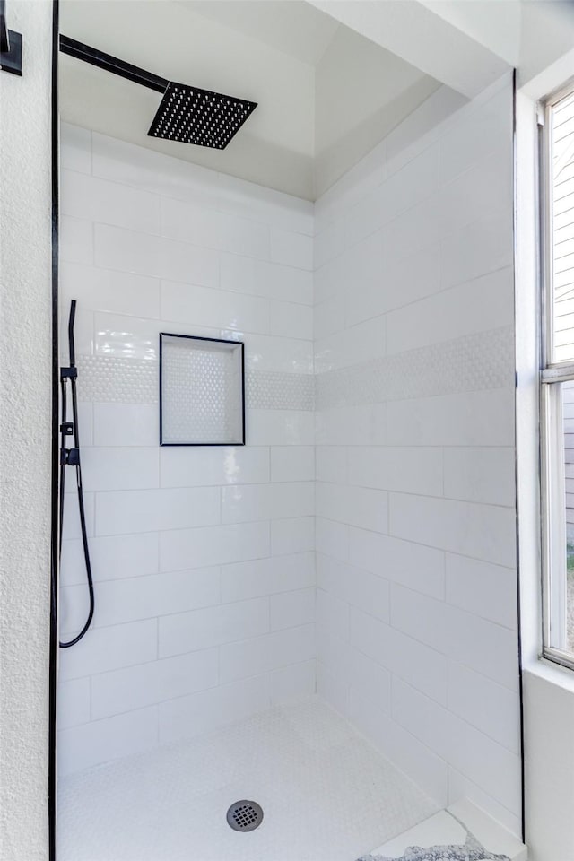 bathroom with a tile shower