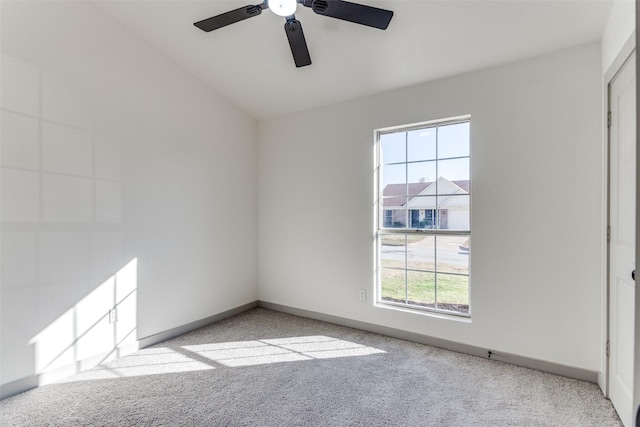 spare room featuring light carpet and ceiling fan