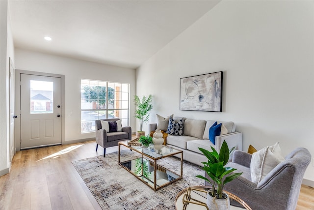 living room with lofted ceiling and light wood-type flooring