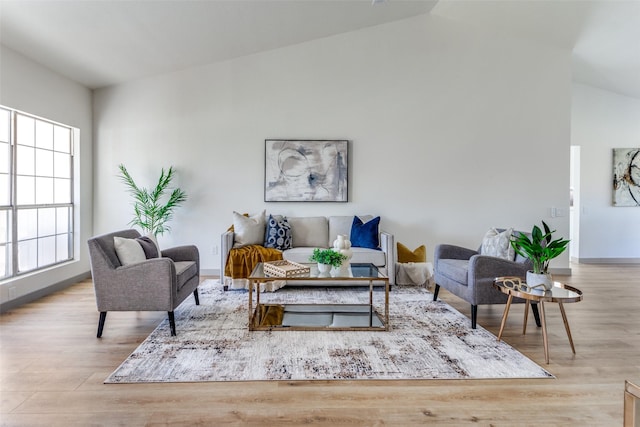 living room with lofted ceiling and light hardwood / wood-style flooring