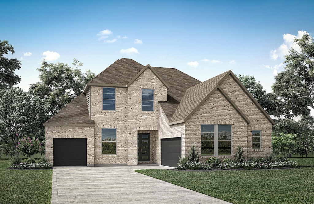 view of front of property with a garage and a front lawn