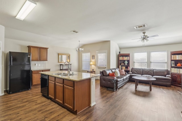 kitchen with sink, a center island with sink, dark hardwood / wood-style floors, and black appliances