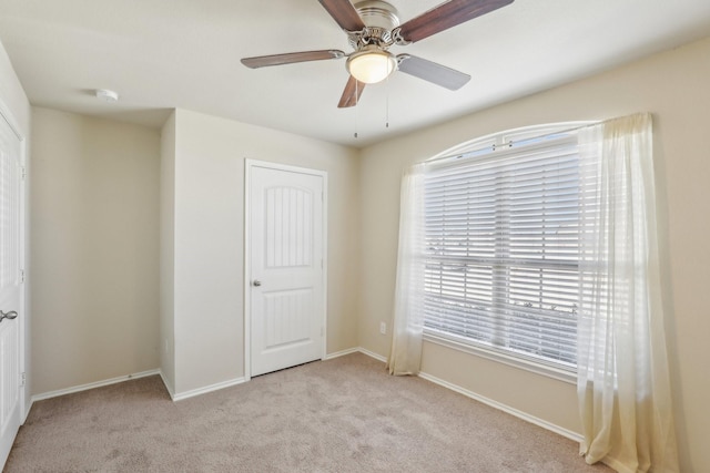 unfurnished bedroom featuring light colored carpet and ceiling fan