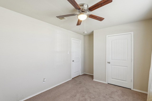 unfurnished bedroom featuring ceiling fan and light carpet