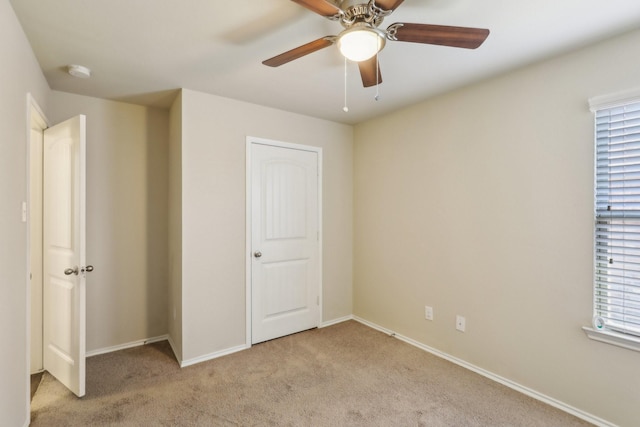 unfurnished bedroom with light carpet and ceiling fan