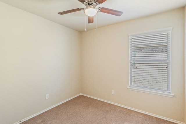 empty room with ceiling fan and carpet floors