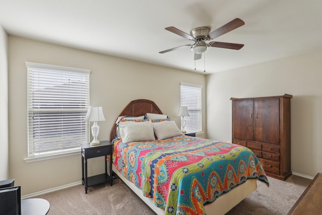 bedroom featuring light colored carpet and ceiling fan