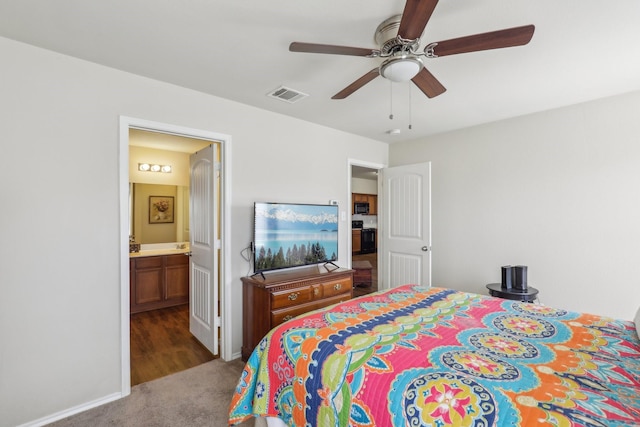 bedroom featuring ensuite bath, ceiling fan, and dark colored carpet