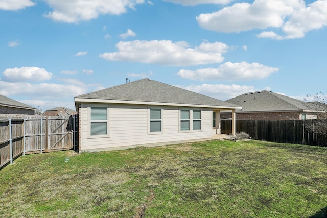 back of property featuring a lawn