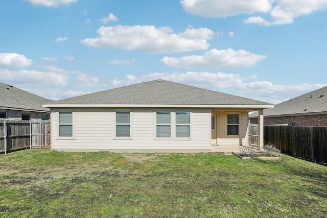 rear view of property with a yard