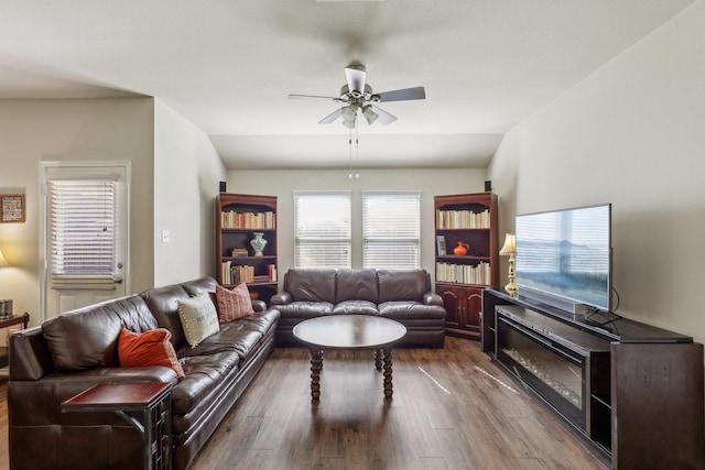 living room with ceiling fan, lofted ceiling, and dark hardwood / wood-style flooring