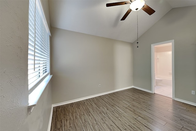 spare room featuring vaulted ceiling, hardwood / wood-style floors, and ceiling fan