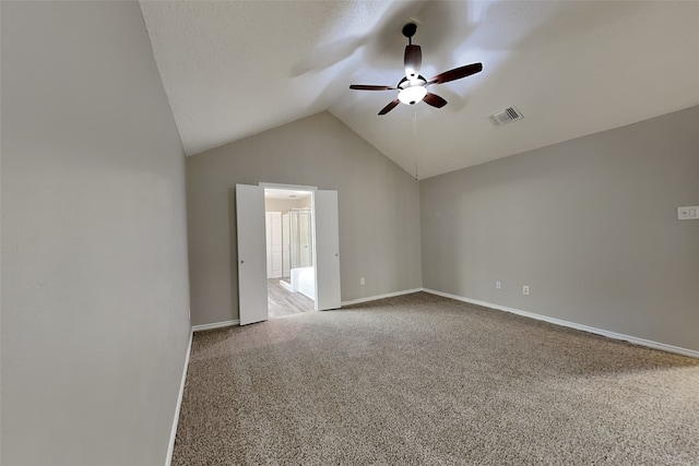 unfurnished room featuring lofted ceiling, carpet flooring, and ceiling fan