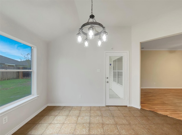 unfurnished dining area with a chandelier and light tile patterned flooring