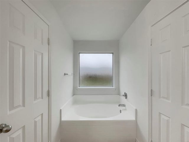 bathroom featuring a relaxing tiled tub