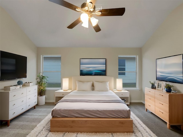 carpeted bedroom featuring lofted ceiling and ceiling fan