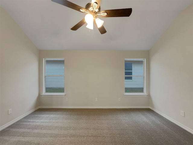 carpeted spare room with ceiling fan and lofted ceiling