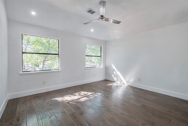 spare room featuring dark wood-type flooring and ceiling fan