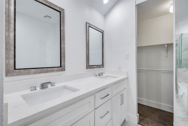 bathroom with vanity and a shower with shower door