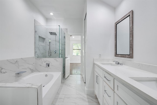 bathroom with shower with separate bathtub and vanity