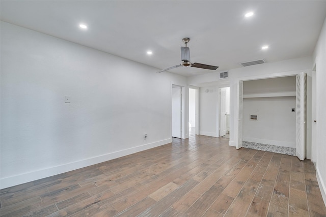 interior space with ceiling fan and wood-type flooring