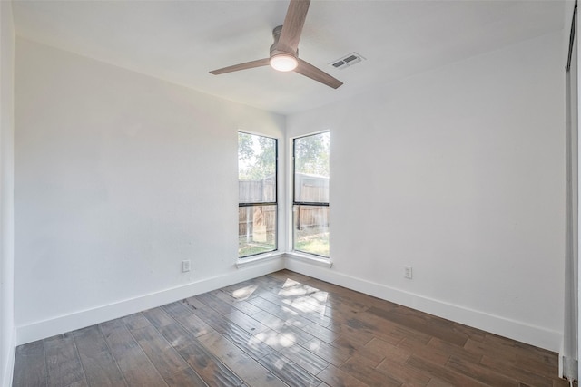 empty room featuring dark wood-type flooring and ceiling fan