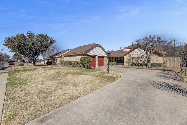 ranch-style home with a garage and a front yard