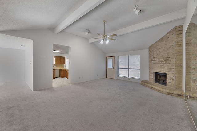 unfurnished living room with light carpet, a brick fireplace, lofted ceiling with beams, and a textured ceiling